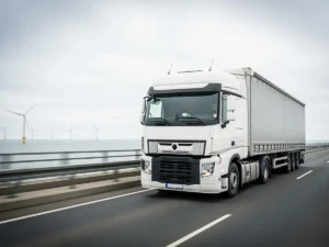Freight transport to Denmark — truck on a sea bridge with wind turbines